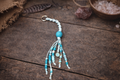 Turquoise & White Beaded Macramé Keychain – Handmade Boho Charm with “Dream Big” Pendant